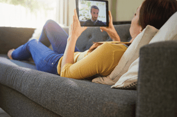 woman talking to a man on a tablet