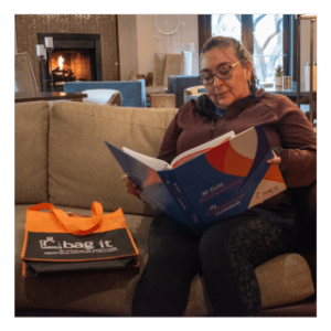 Woman with Spanish bicultural bag sitting on couch