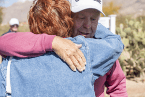 Two people hugging at 2025 Cologuard Classic